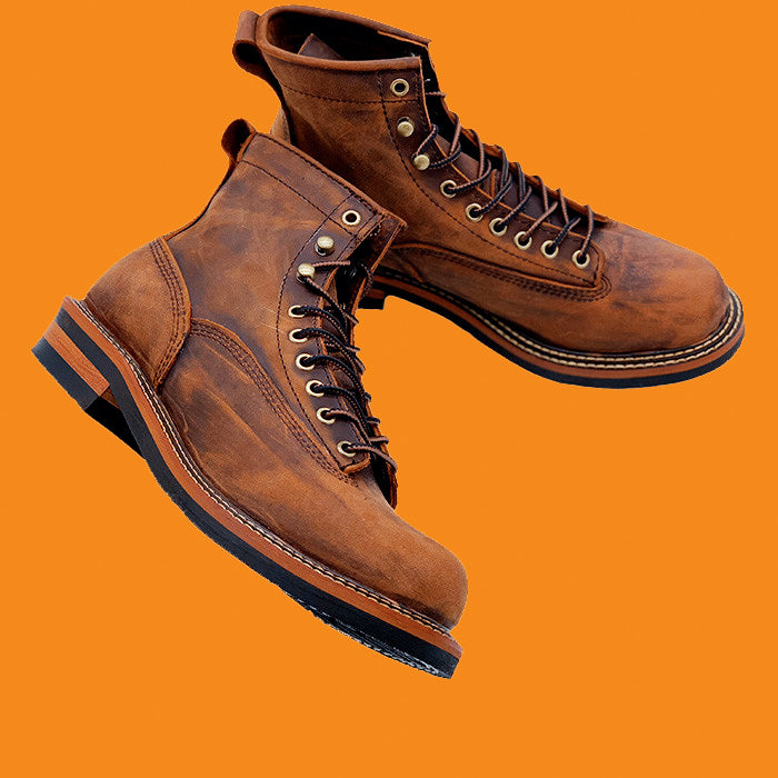 Brown leather boots on an orange background