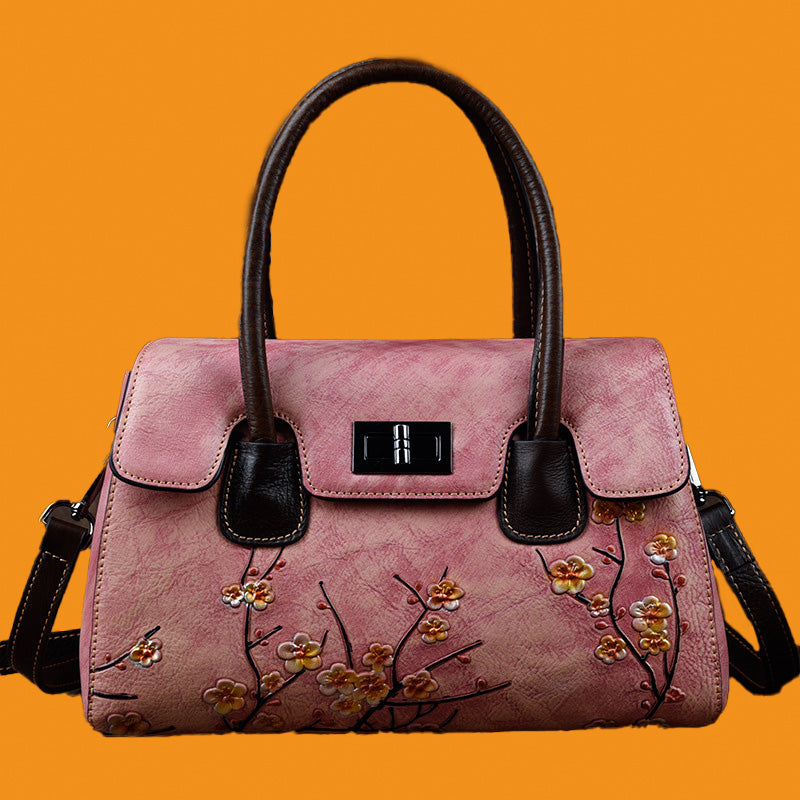 Pink handbag with floral design on an orange background