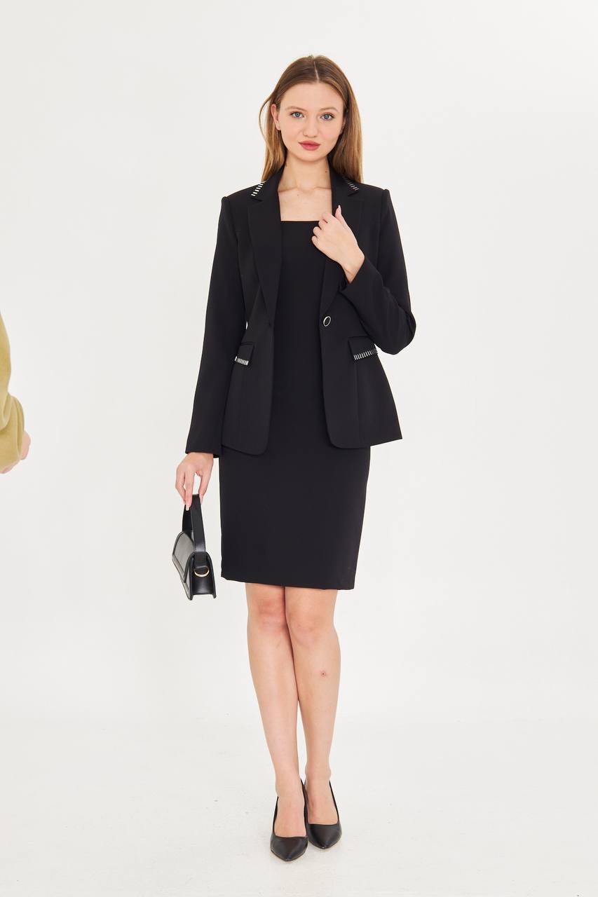 Woman wearing a black suit on a white background