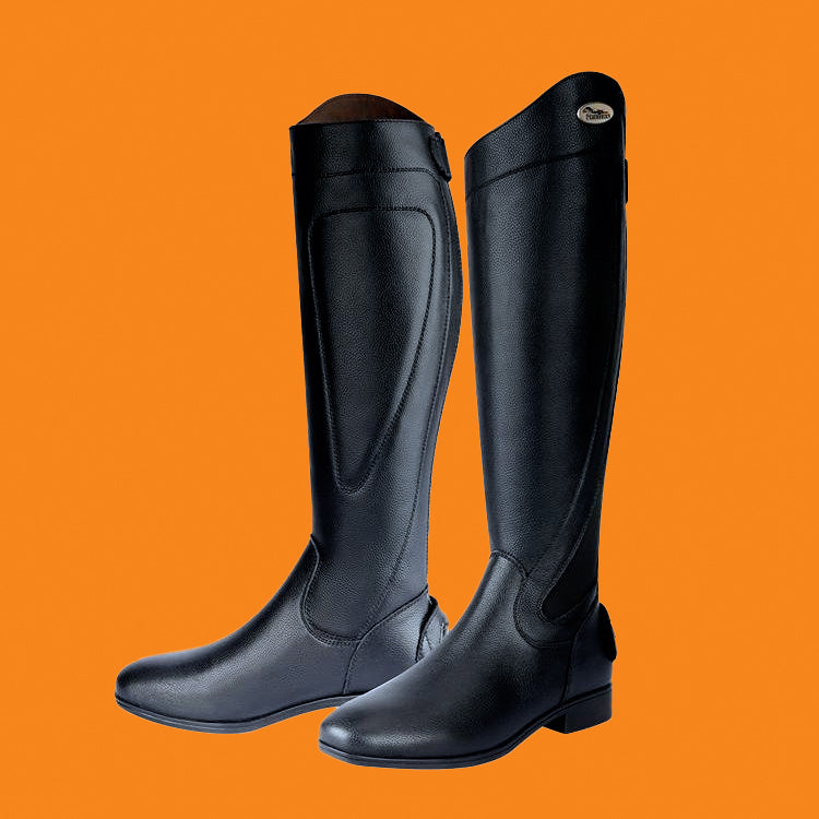Black riding boots on an orange background