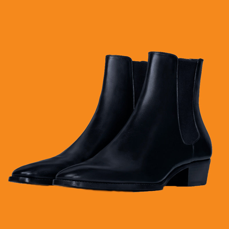Black ankle boots on an orange background