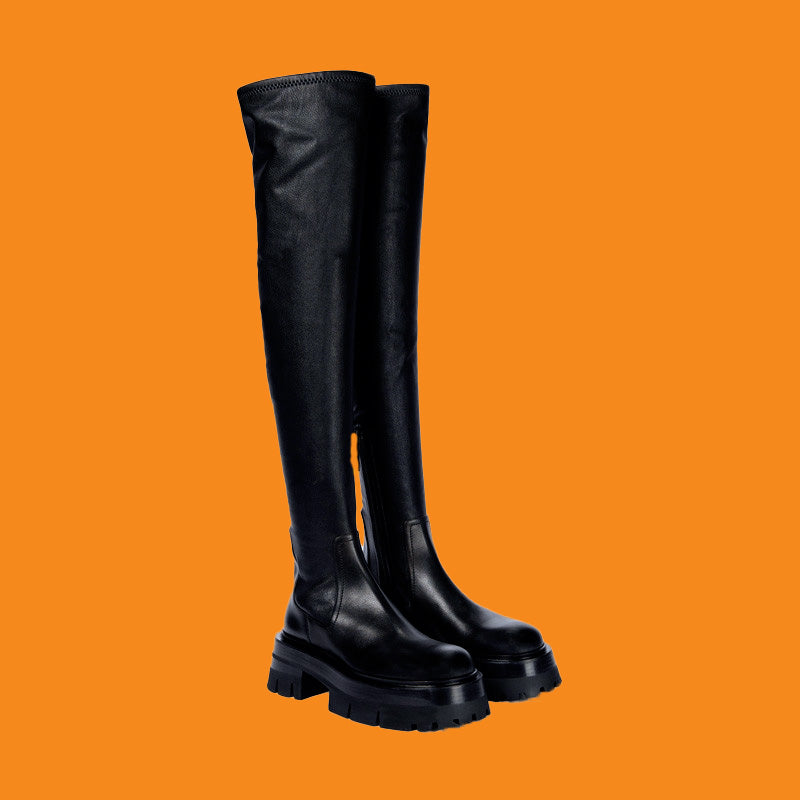 Black knee-high boots on an orange background