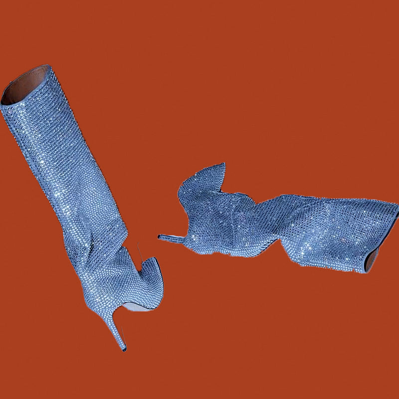 Blue high-heeled shoes with a textured finish on an orange background