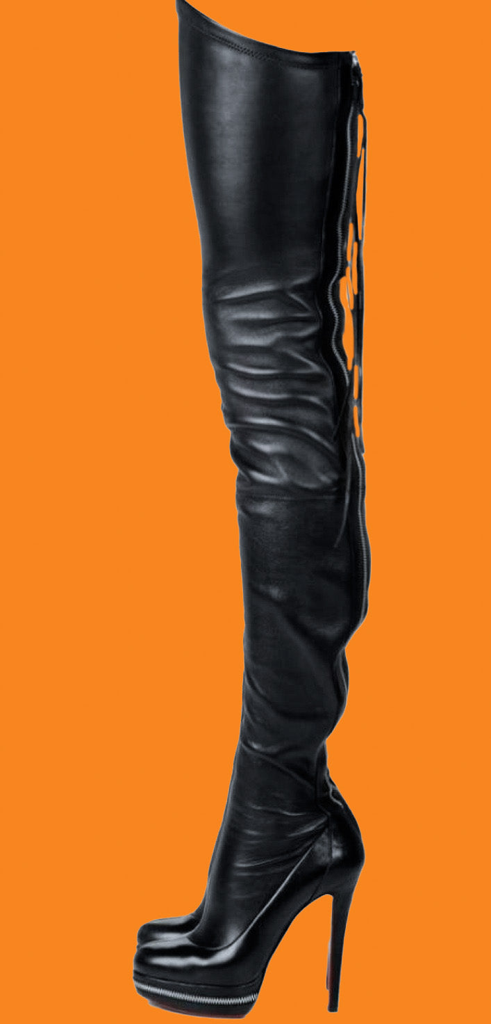 Black knee-high boot with high heel on an orange background