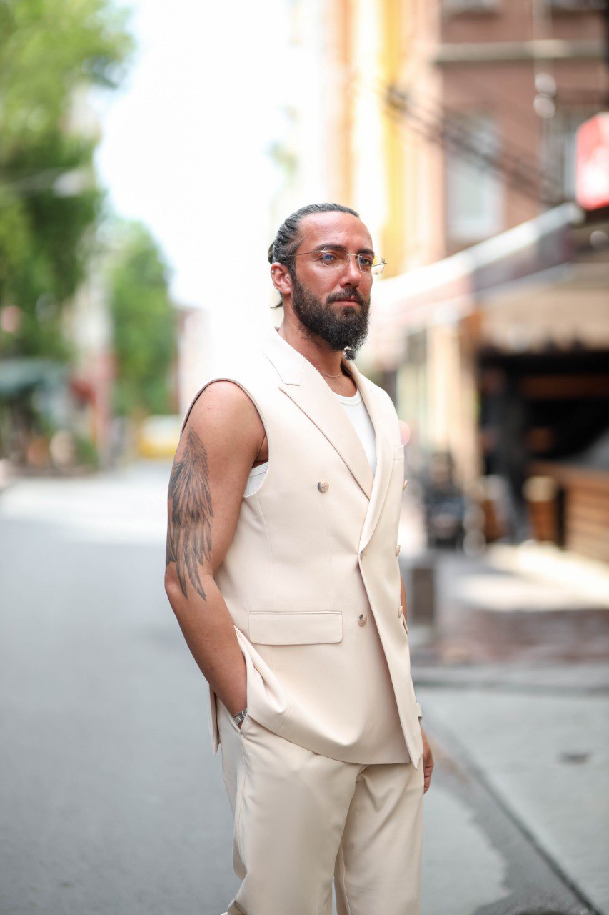 Man in a beige suit standing on a city street