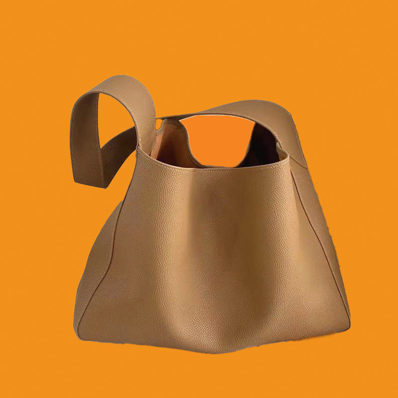 Brown leather handbag on an orange background