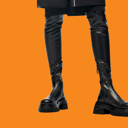 Black knee-high boots on an orange background