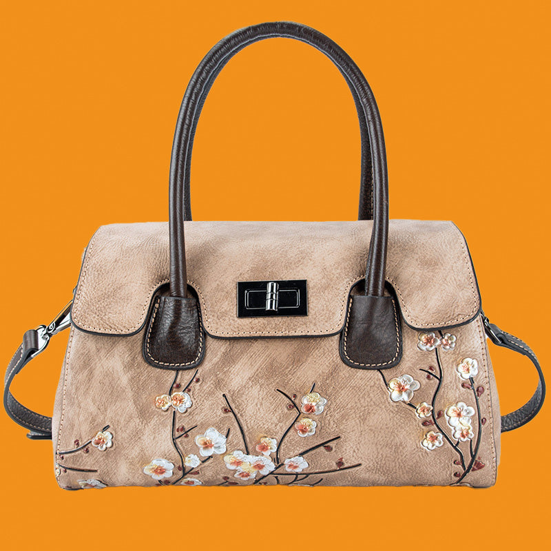 Beige handbag with floral embroidery on an orange background