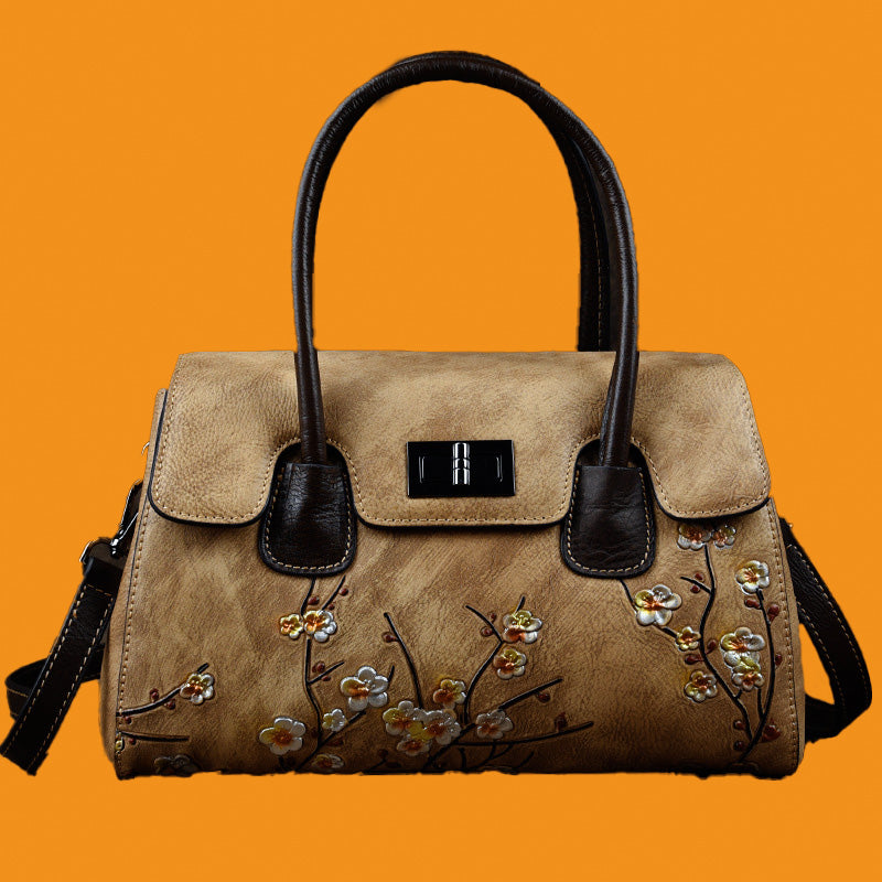 Beige handbag with floral embroidery on an orange background