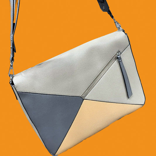 Geometrically designed handbag with a mix of beige, gray, and white on an orange background