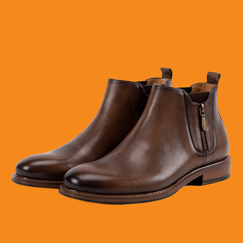 Pair of brown leather boots on an orange background