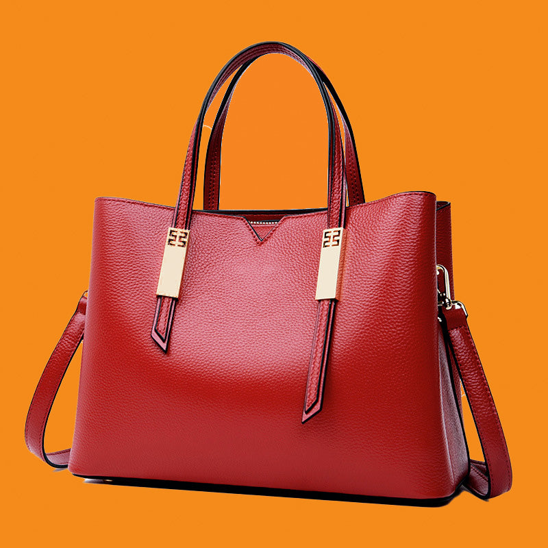 Red handbag with gold accents on an orange background