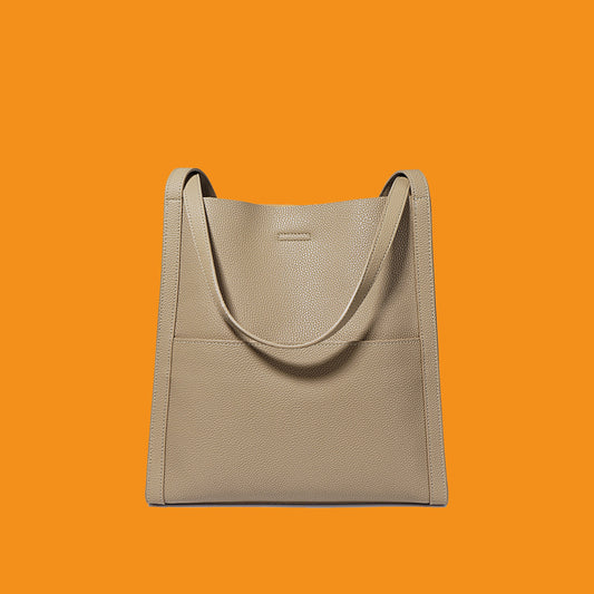 Beige handbag on an orange background