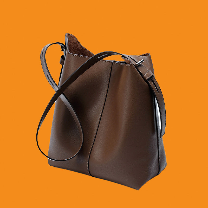 Brown leather handbag on an orange background