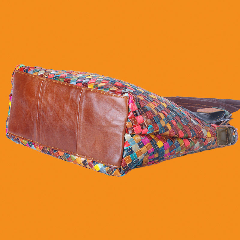 Colorful woven bag with brown leather corner on an orange background