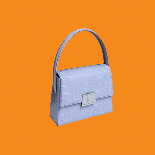 Light blue handbag with a handle on an orange background