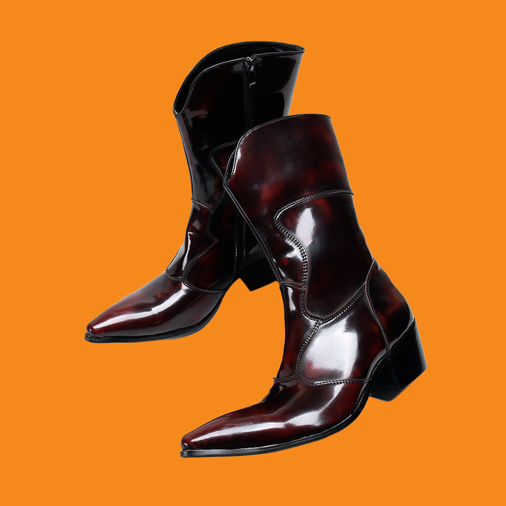 Shiny brown cowboy boots on an orange background