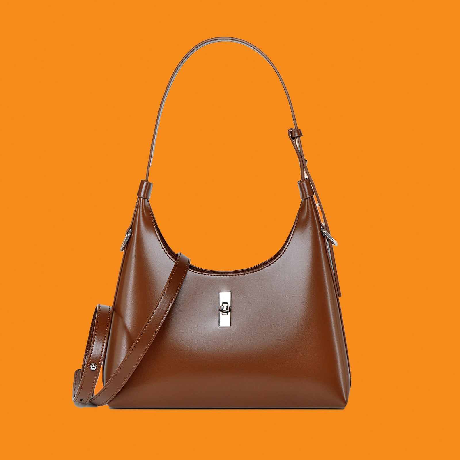 Brown handbag with a shoulder strap on an orange background