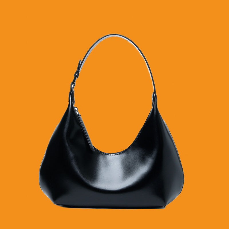 Black handbag on an orange background