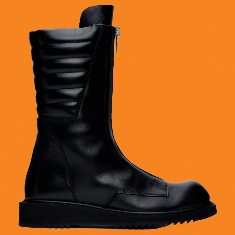 Black leather boot with a zipper on an orange background