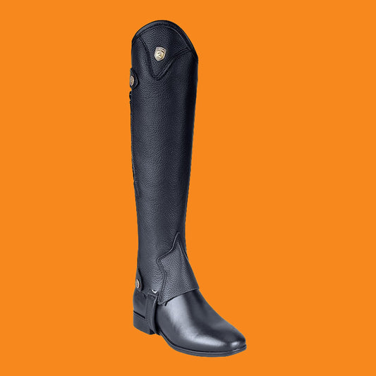 Black riding boot on an orange background