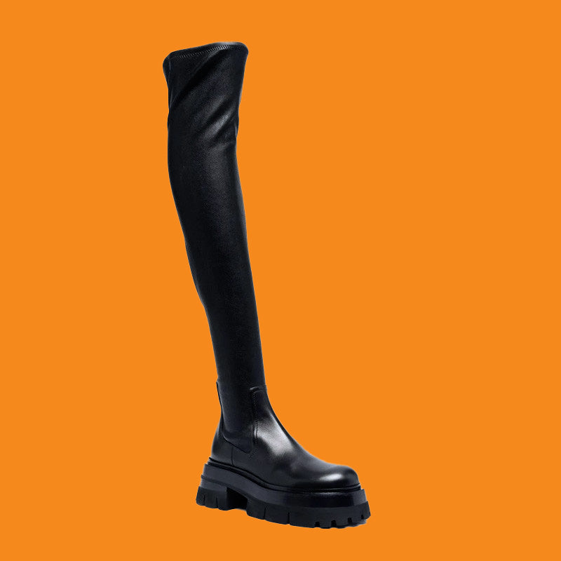 Black knee-high boot on an orange background