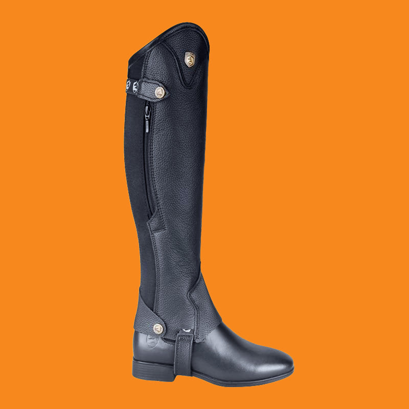 Black riding boot on an orange background