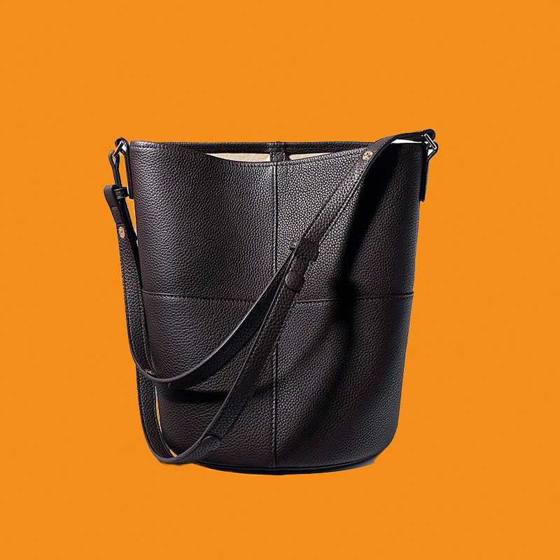 Black leather handbag on an orange background