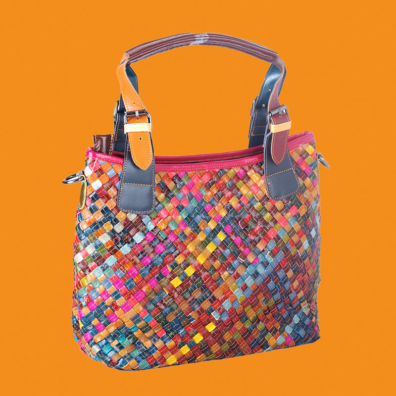 Multicolored woven handbag on an orange background
