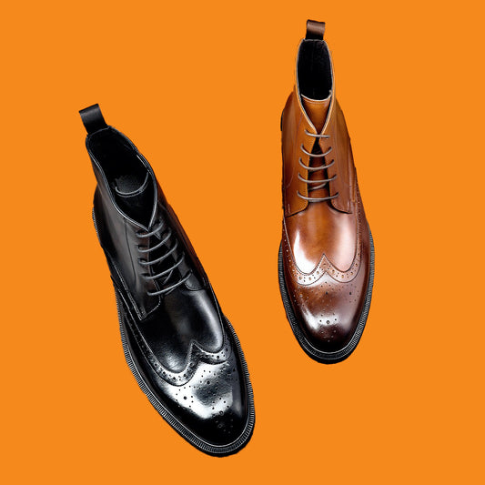 Black and brown leather boots on an orange background