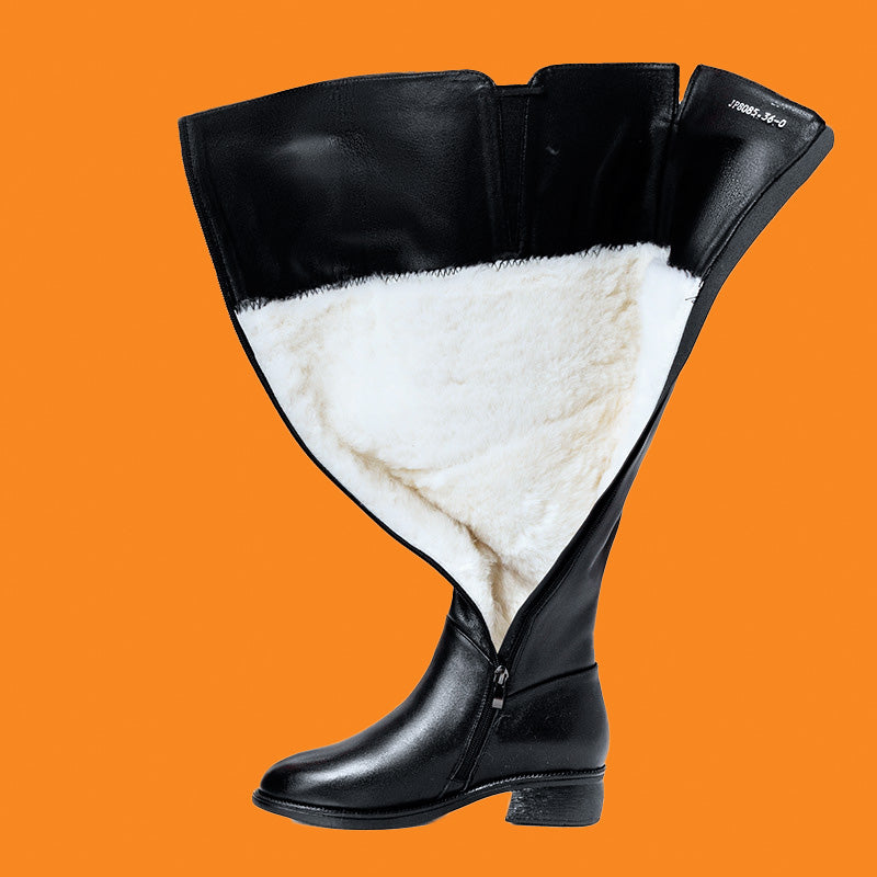 Black boot with white fur lining on an orange background
