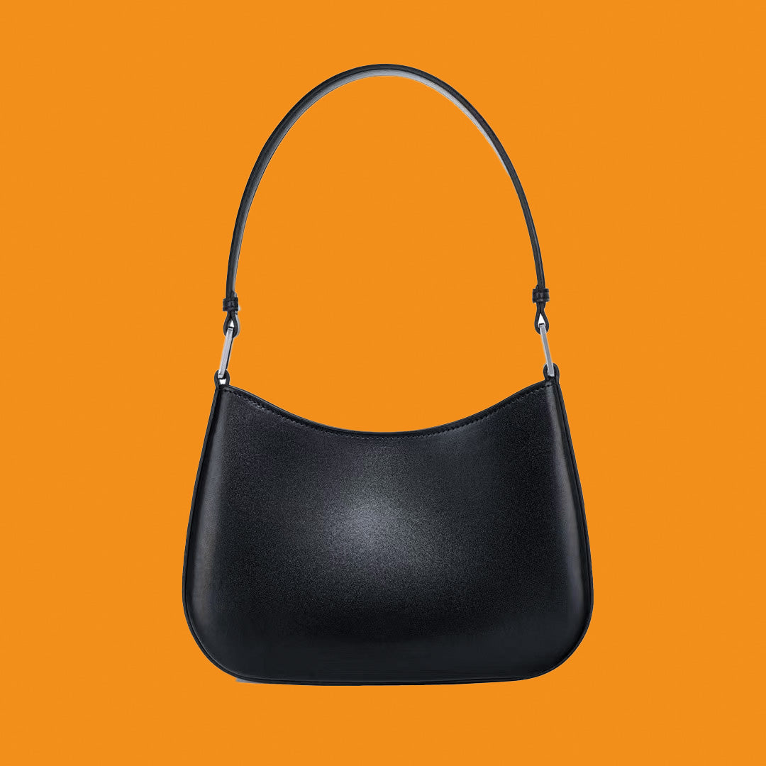 Black handbag on an orange background