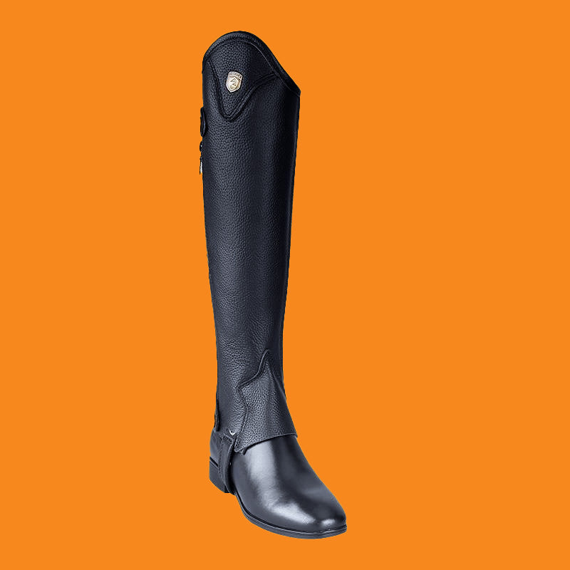 Black riding boot with a gaiter on an orange background