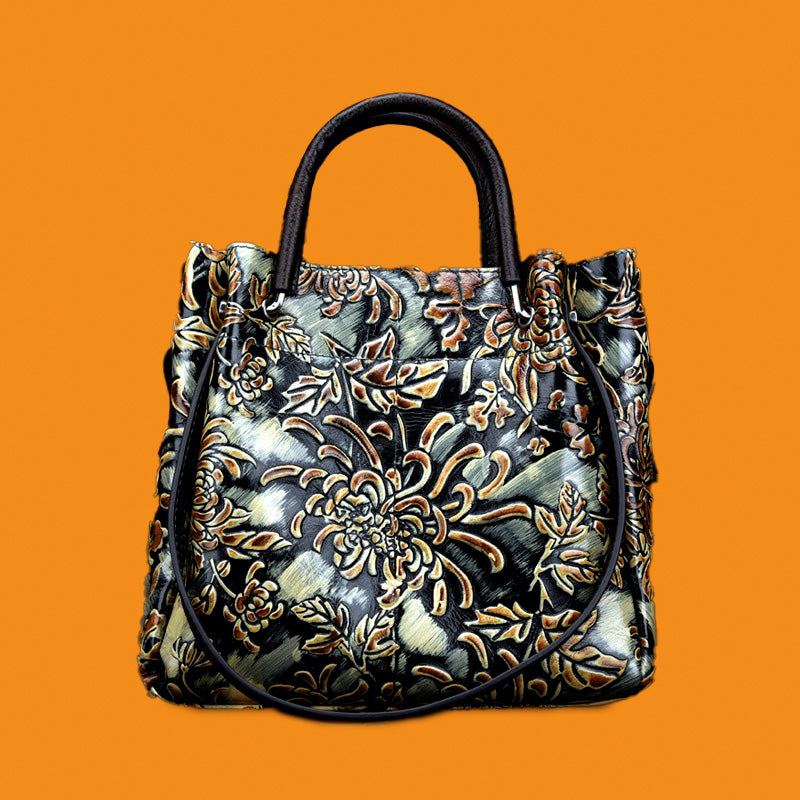 Decorative handbag with floral patterns on an orange background