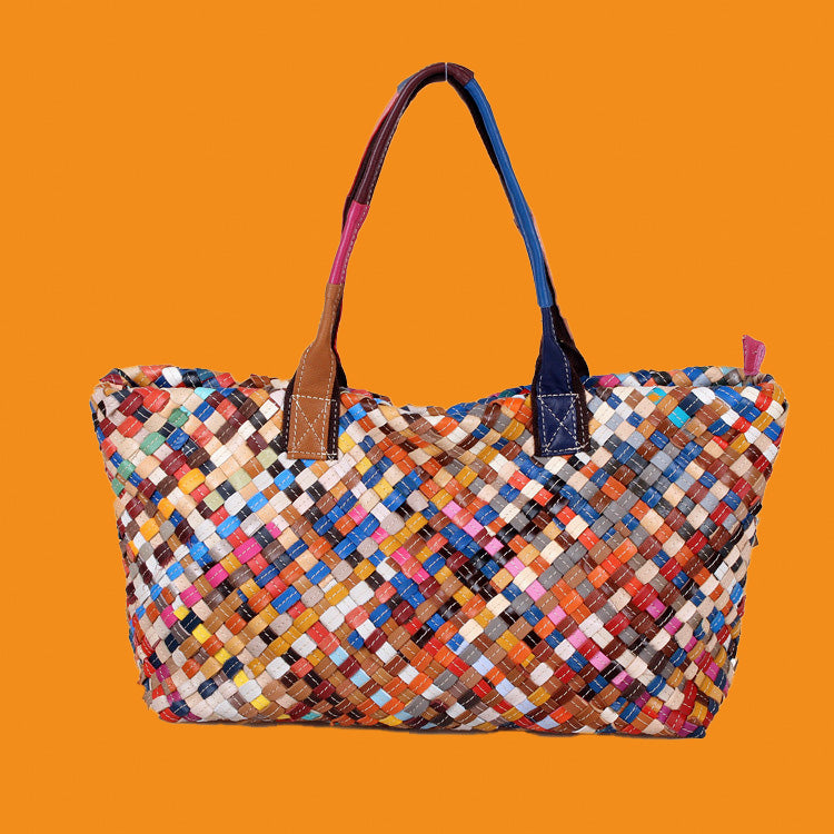 Multicolored woven handbag on an orange background