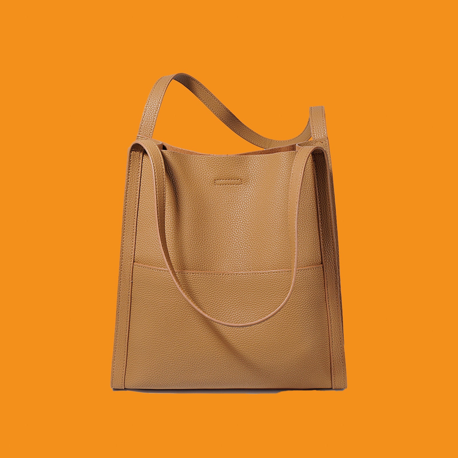 Tan handbag on an orange background