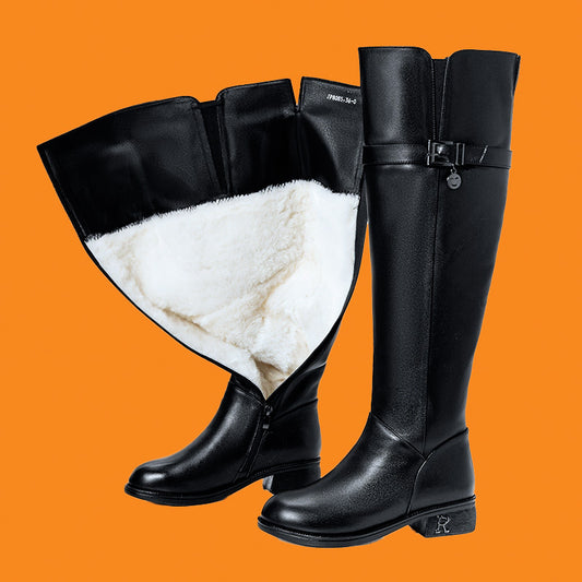 Black knee-high boots with white fur lining on an orange background