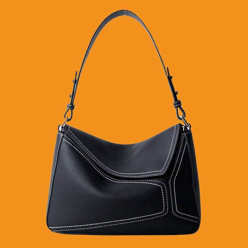 Black handbag on an orange background