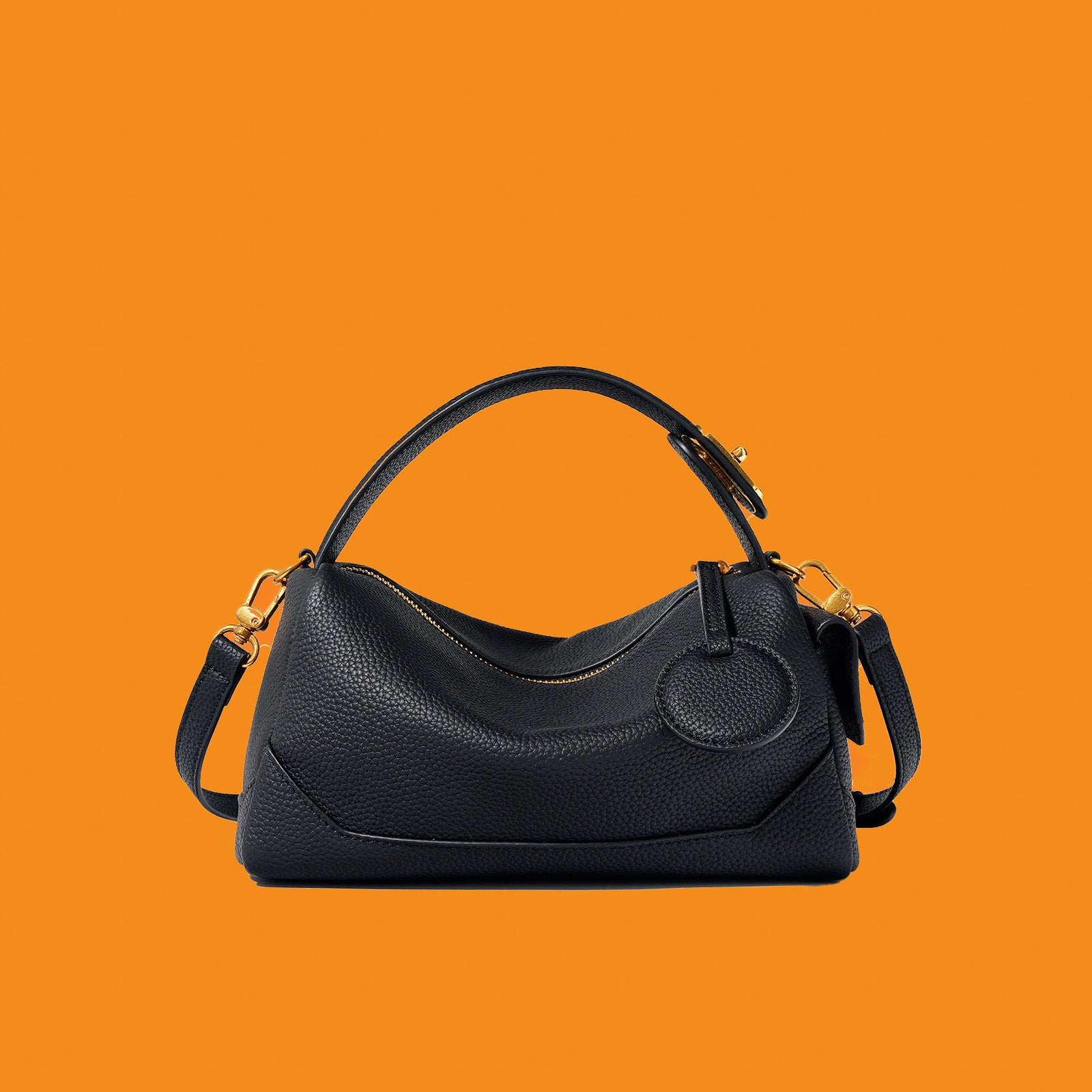 Black handbag on an orange background