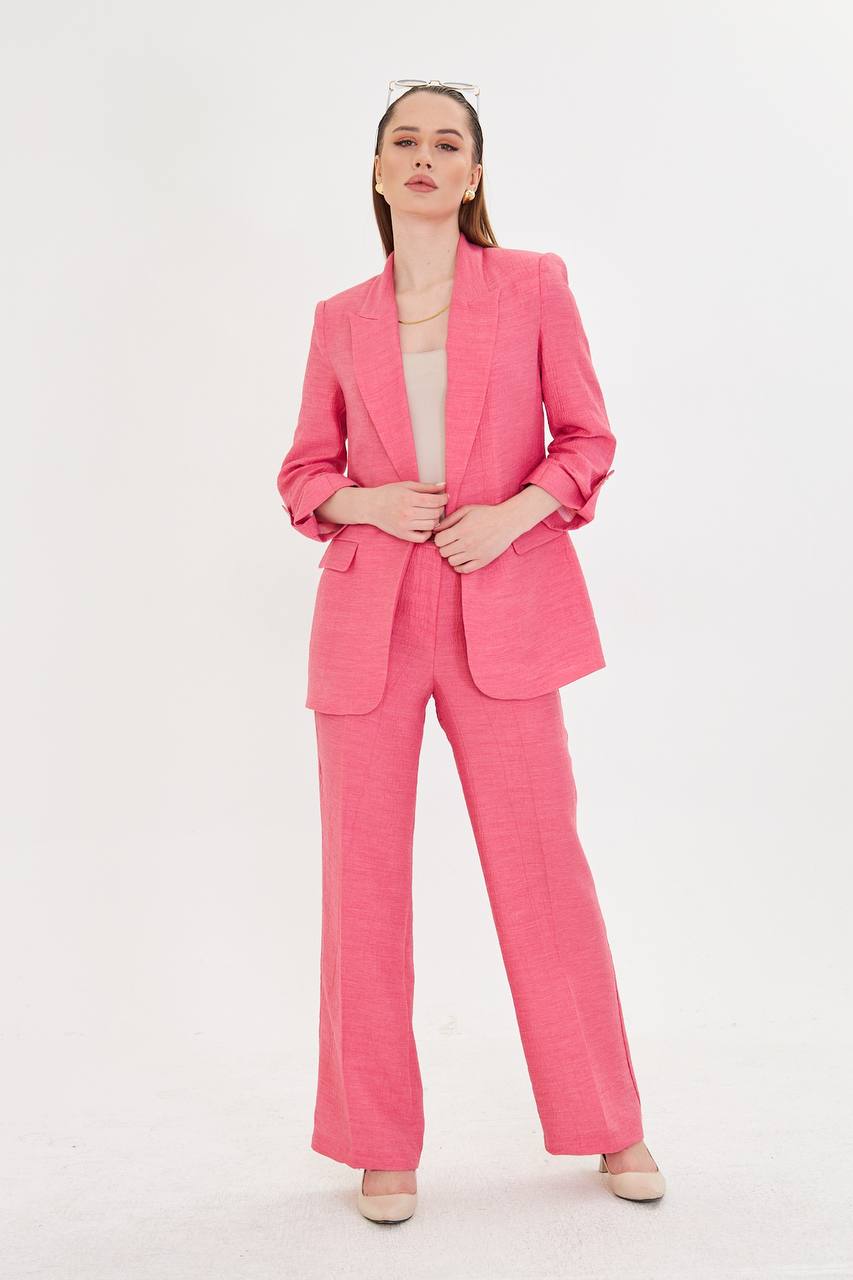 Woman wearing a bright pink suit on a white background
