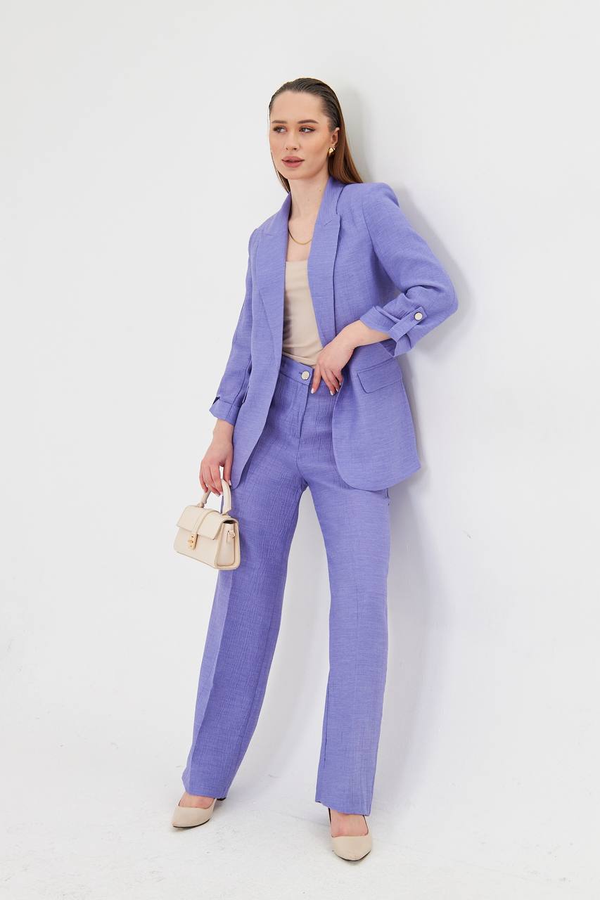 Woman wearing a light purple suit with a white background