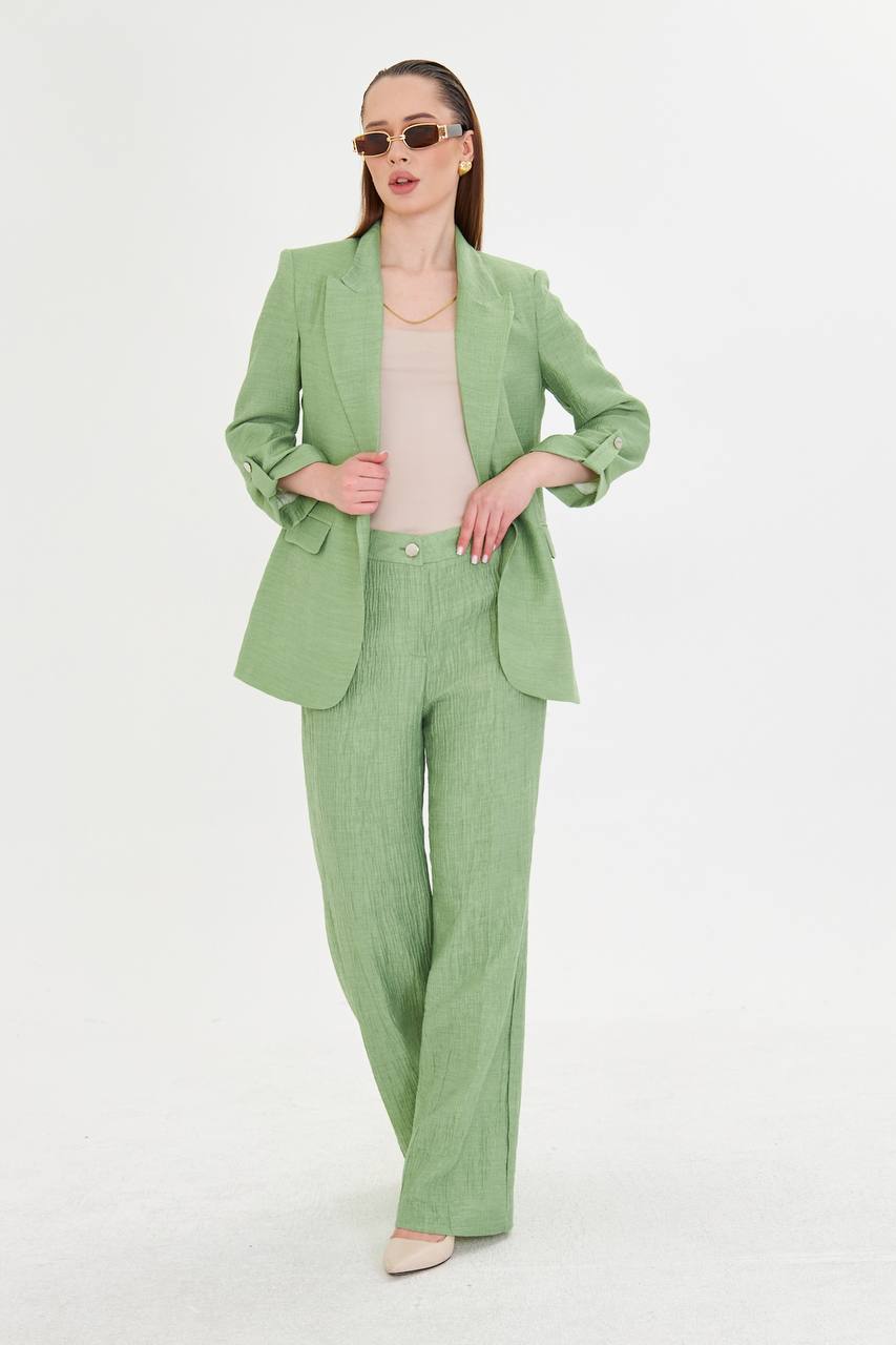 Woman wearing a green suit on a white background