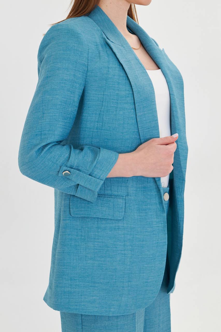 Teal suit jacket worn by a person on a white background