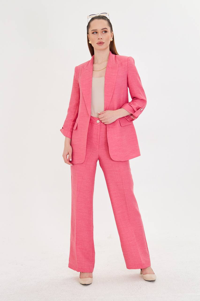 Woman wearing a pink suit on a white background