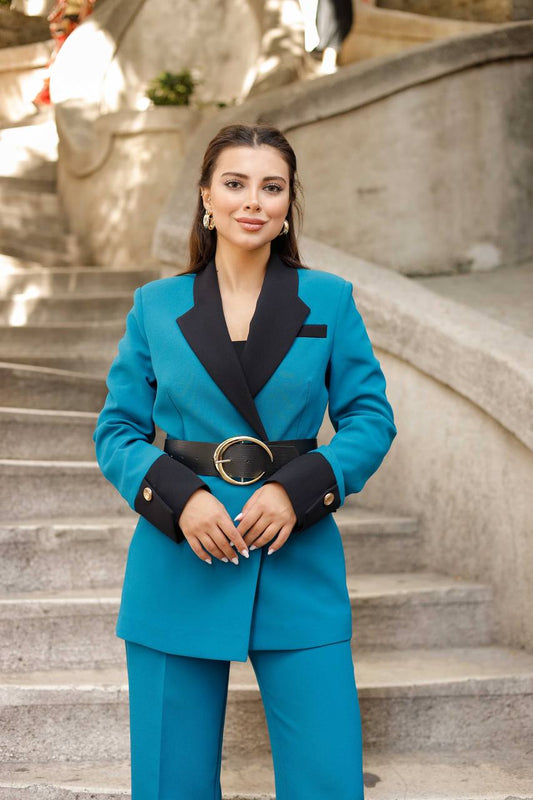 Woman in a blue suit standing on stone steps outdoors