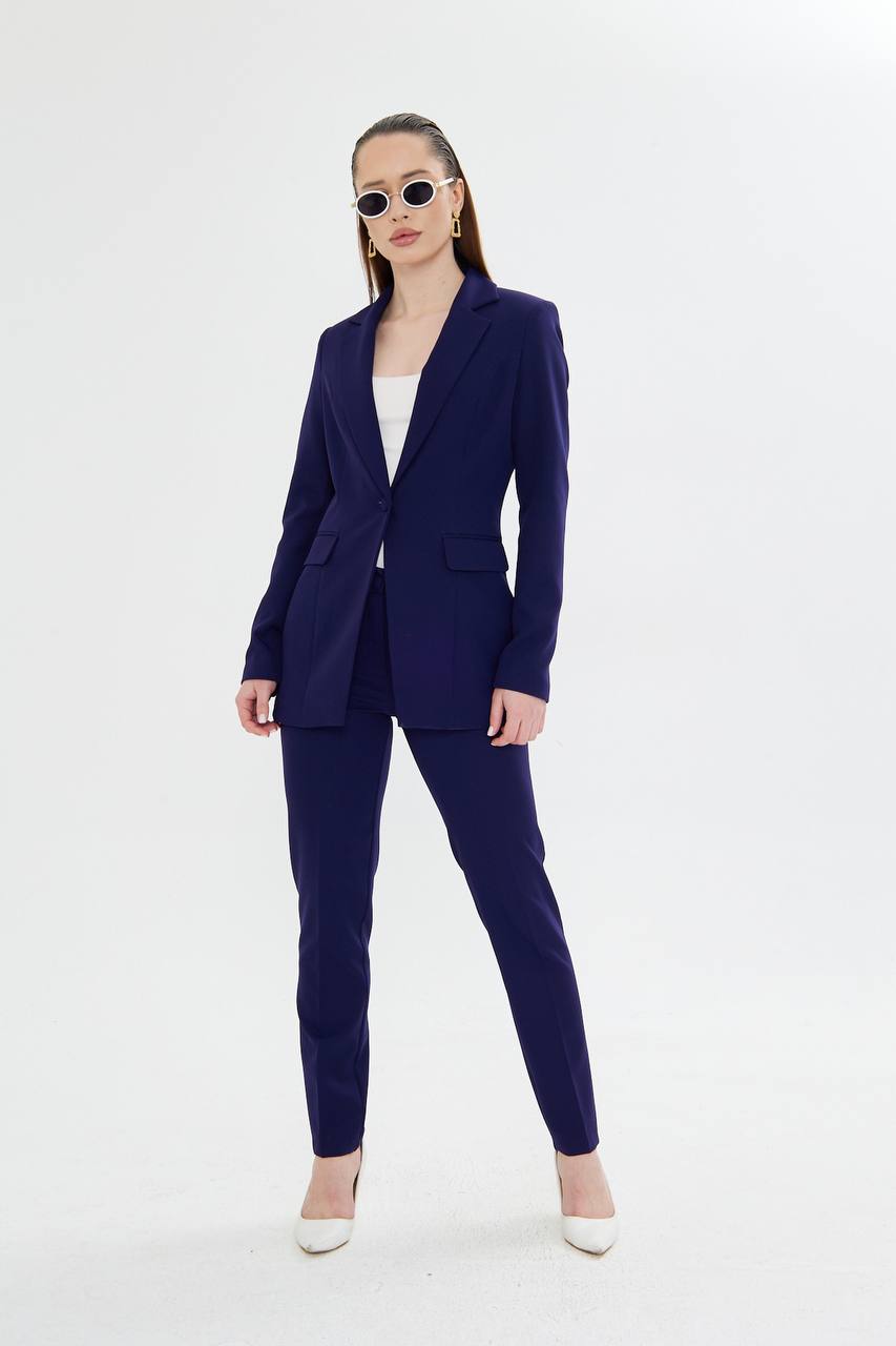 Woman wearing a navy blue suit on a white background