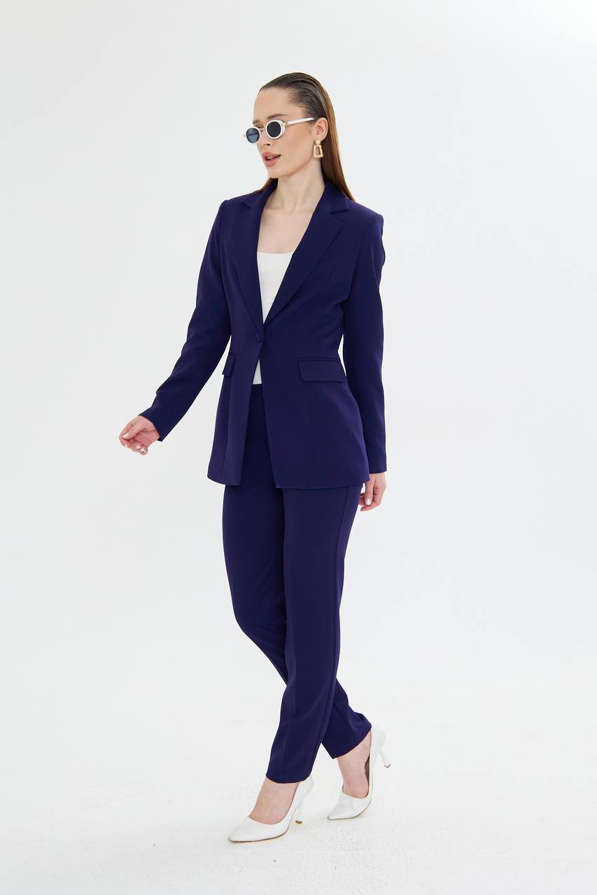 Woman wearing a navy blue suit on a white background