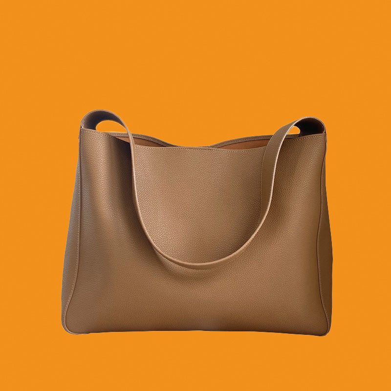 Brown leather handbag on an orange background