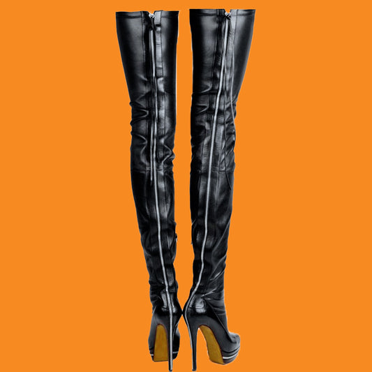 Black leather over-the-knee boots with high heels on an orange background