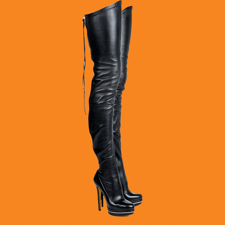 Black knee-high boots on an orange background